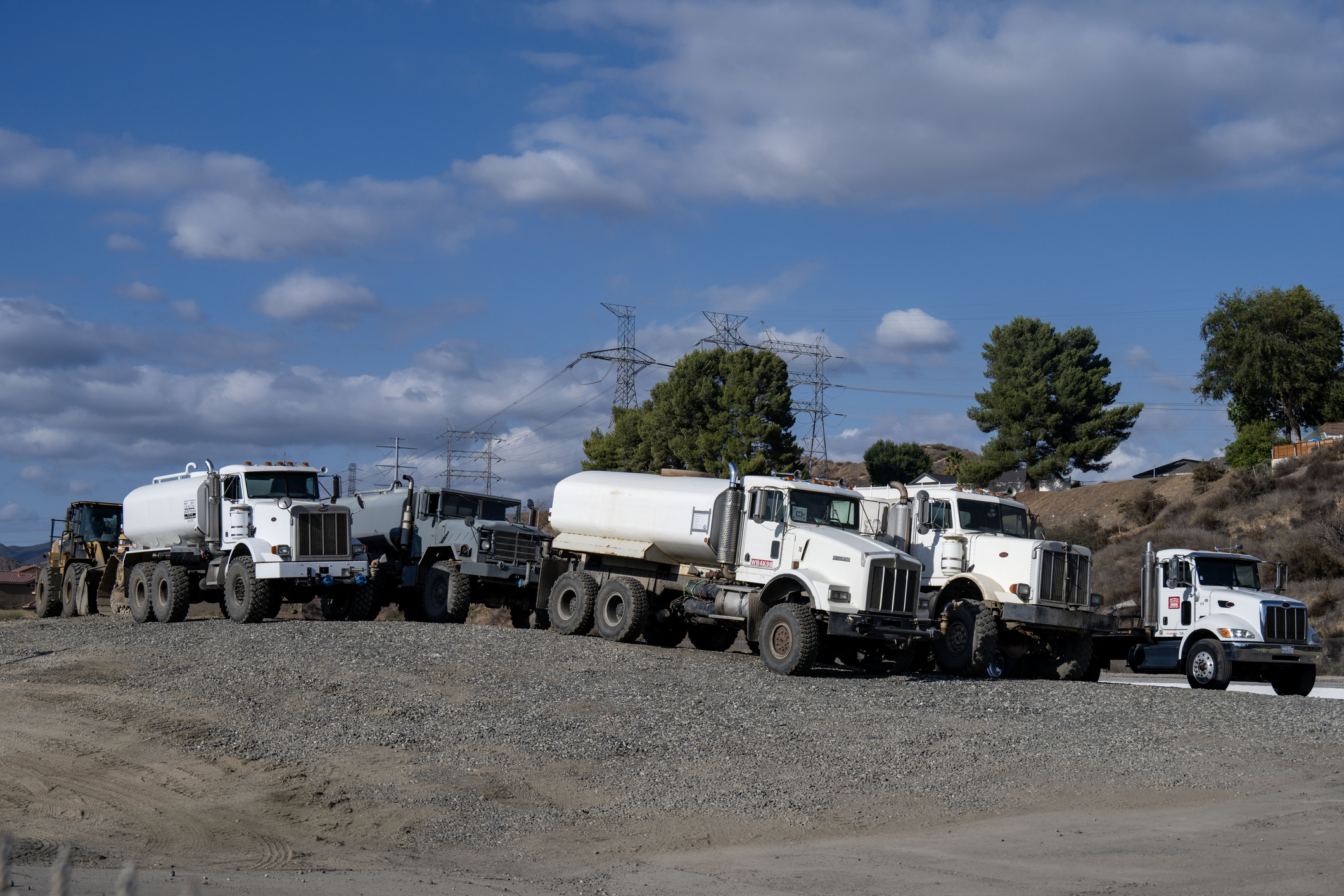A public works crew is starting to clean out the storm drains in the northern part of the Santa Clarita Valley, California with a bunch of these water trucks