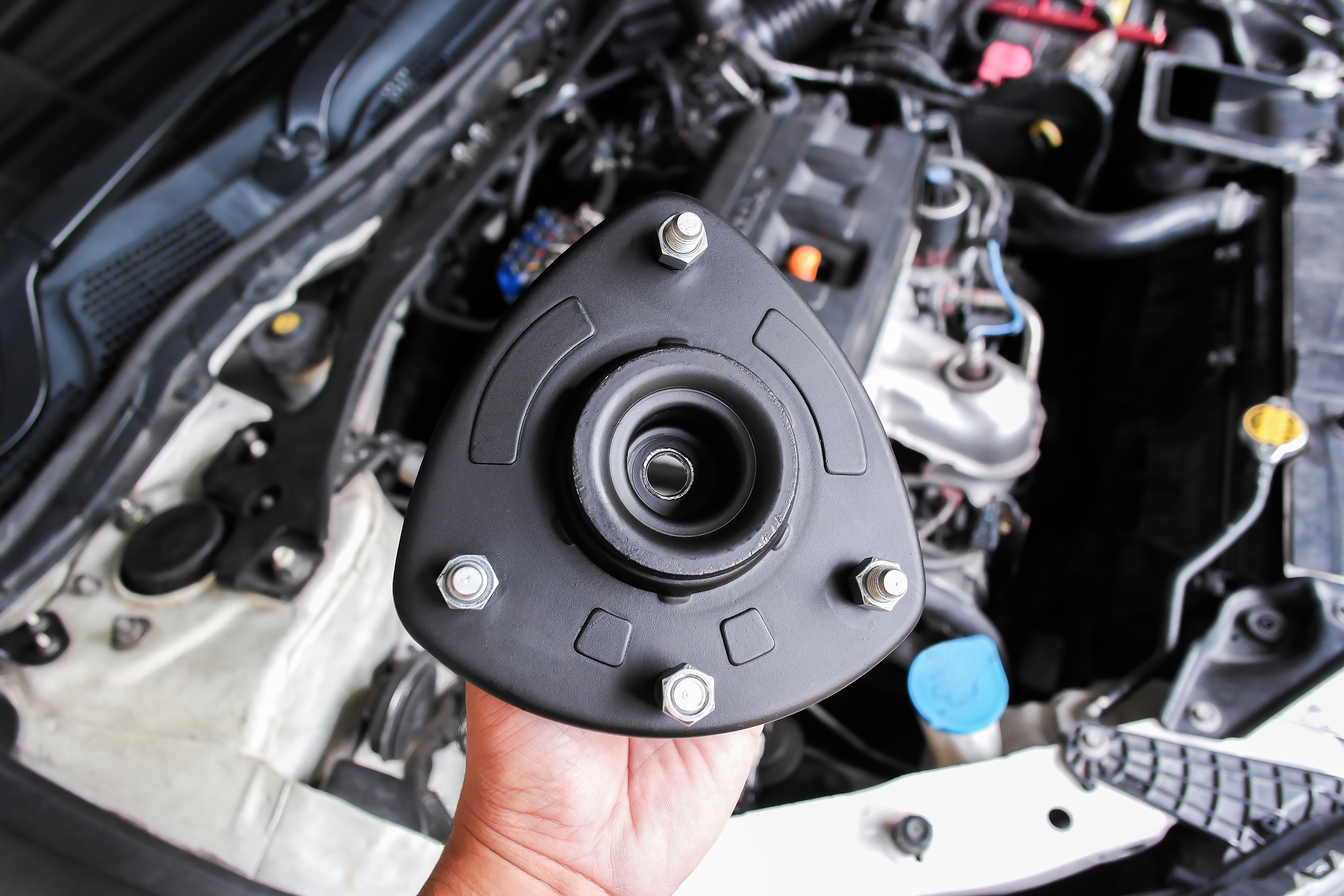 Shock Absorber Strut Mount, Top strut mount of suspension shock absorber strut in mechanic hand.