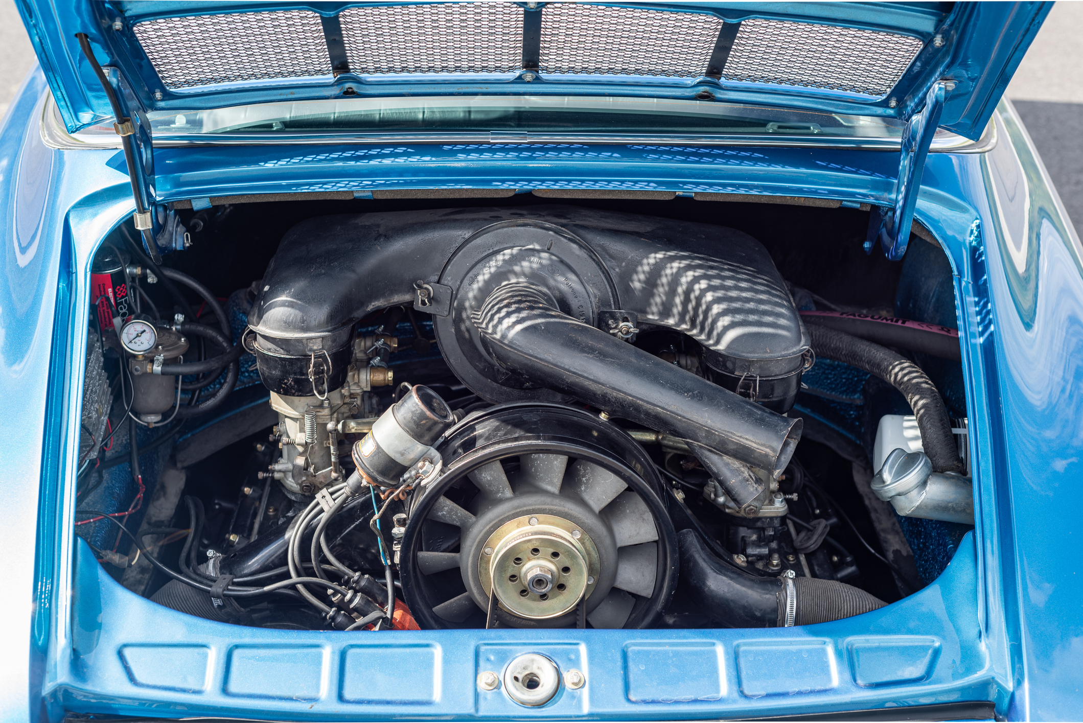 Vilnius, Lithuania - August 10, 2023: Original engine of 1971 Porsche 911 Targa in a metallic blue. Whole car including engine has been fully rebuilt. Clean engine bay view.